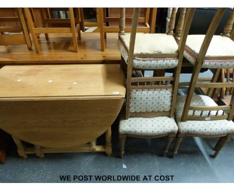 A light oak drop leaf table (H75 x L160 x W110cm) and four upholstered oak chairs