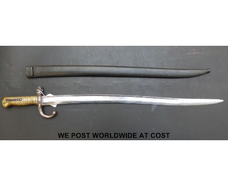 An 1866 pattern yataghan bladed chassepot French bayonet and scabbard, with the manufacturer's engraving to edge of 57.5cm bl