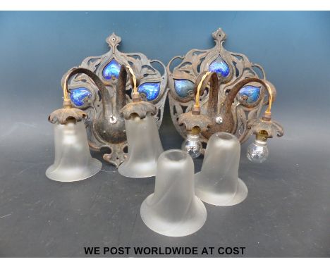 A pair of enamel and embossed metal Art Nouveau / Arts & Crafts style light fittings with hanging shades