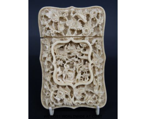 A 19thC Chinese carved ivory card case with exceptionally deep and intricate carving in a central cartouche of two warriors f