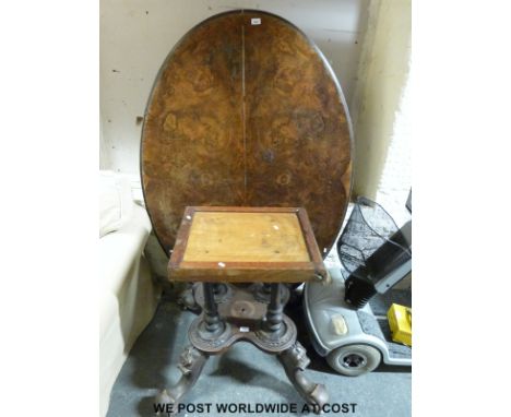 A 19thC burr walnut oval breakfast table supported by four turned columns, then four gnurled legs raised on ceramic castors (