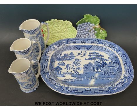 A blue and white meat plate, a graduated set of three blue and white jugs decorated with Oriental scenes, a Carltonware dish 
