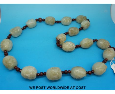 A 19th/20thC Chinese Buddhistic carved jade lohan Mala (necklace) the 18 carved jade heads separated by small stones/nuts.