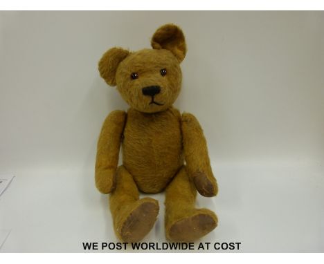 A Steiff style mohair bear with humped back, cocked feet and glass eyes 