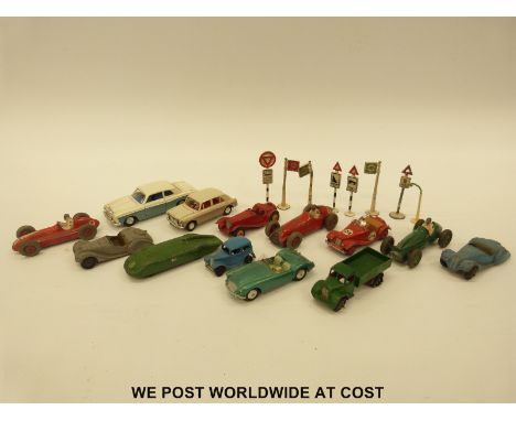 Thirteen Corgi, Dinky and Spot-on diecast model vehicles together with nine Dinky road signs and bus stops.