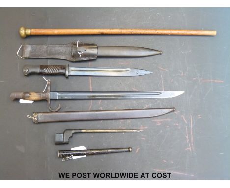 Three WWII era bayonets including German and Japanese together with a swagger stick