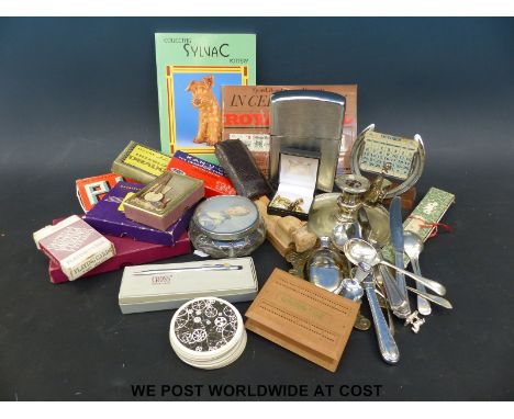 A box of collectables to include playing cards, novelty jumbo size lighter, horseshoe calendar, flatware etc.