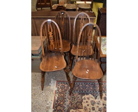 A set of four elm seat and stick back kitchen chairs