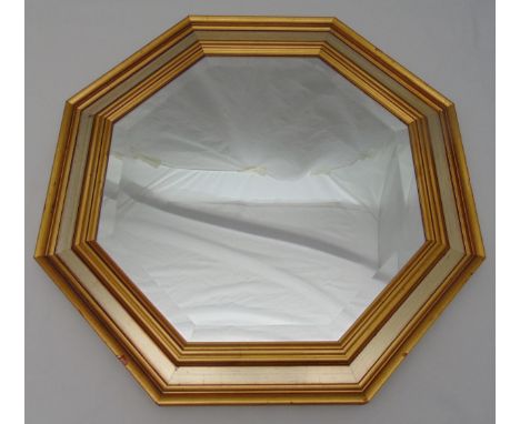 An octagonal wall mirror with moulded gilded wooden frame, 63.5 x 63.5cm