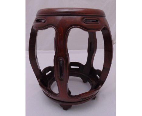 An oriental wooden garden seat of pierced barrel form on bracket feet, 45cm (h)