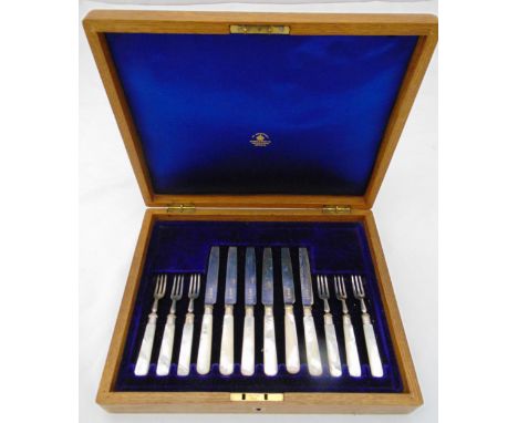A Mappin and Webb cased set of six pairs of hallmarked silver dessert eaters with Mother of Pearl handles Sheffield 1914
