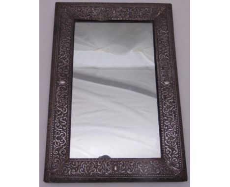 A rectangular silver plated wall mirror with scroll chased beaded border, 53 x 36cm