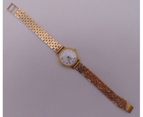 Rotary ladies gold plated wristwatch on a 9ct gold articulated bracelet