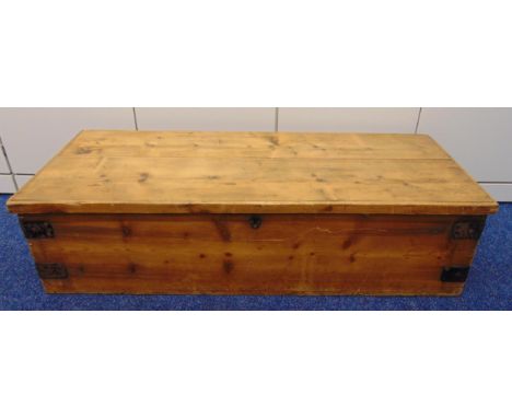 A rectangular pine trunk, metal bound side handles and hinged cover, 120 x 49 x 30cm