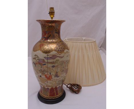 An oriental Satsuma baluster vase decorated with figures in a stylised landscape, converted to a table lamp on raised hardwoo