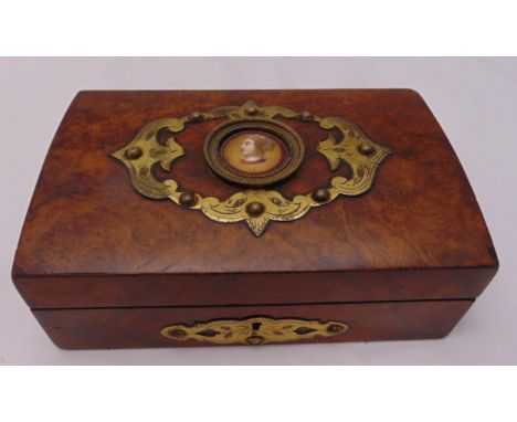 A continental rectangular walnut jewellery box circa 1880, the hinged cover set with an enamel portrait within applied scroll