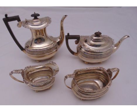 A hallmarked silver four piece tea and coffee set, rounded rectangular with gadroon and shell borders on four bun feet, teapo