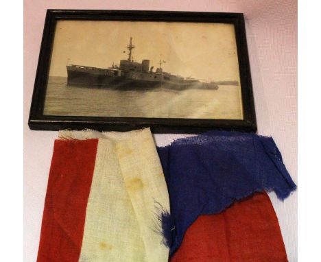 Dutch WWII period photograph of the ship Abraham Crijnssen, with a fragment of flag material. The ship was disguised as an is