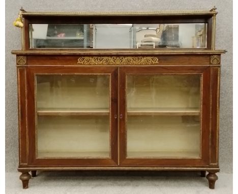 A Regency rosewood pier cabinet or chiffonier with ormolu mounts and brass inlay with a scrolling foliate design raised on tu