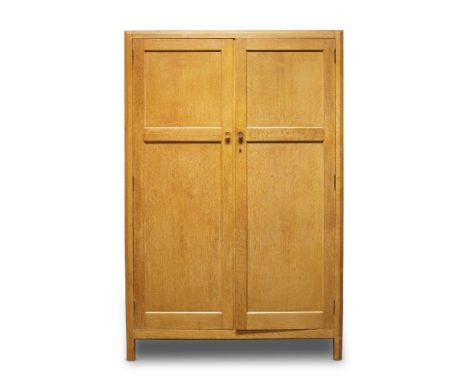 Heal's, a limed oak double wardrobe    c.1930, with applied 'Ivorine' manufacturer's label to interior    With two paneled do