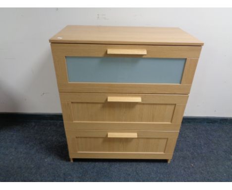 An Ikea light oak three drawer chest 