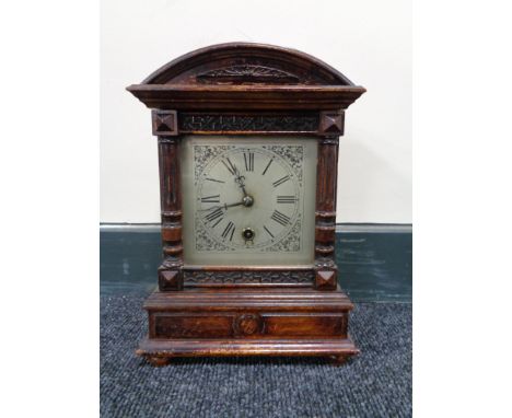 An Edwardian stained beech mantel clock 