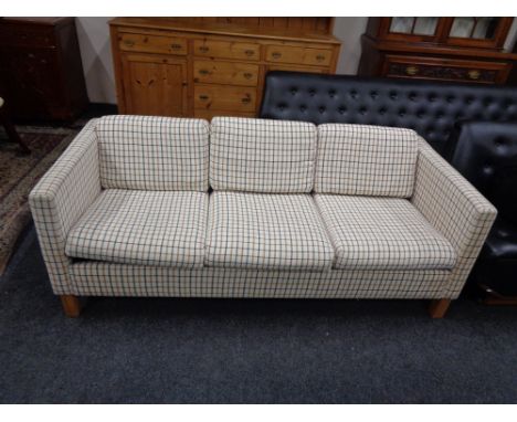 A Continental three seater settee upholstered in light tartan fabric 