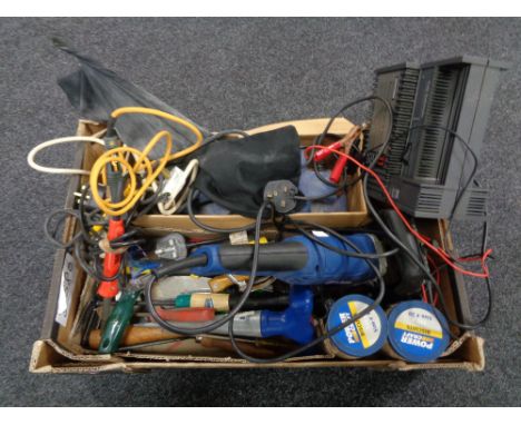 A box containing tools, woodworking tools, battery charger and tester