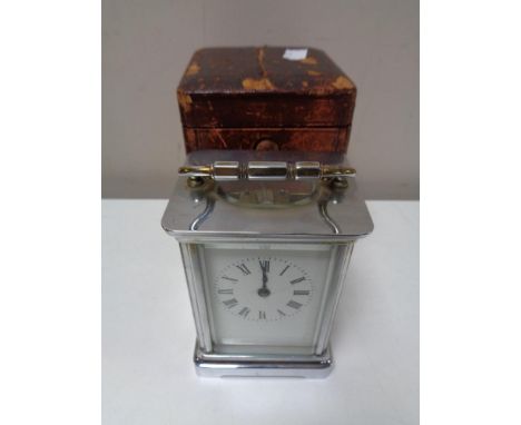 An early twentieth century chrome carriage clock in leather case  CONDITION REPORT: Winds but does not run. Losses to enamel 