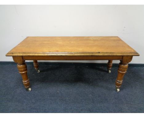 A Victorian oak table on ceramic casters 