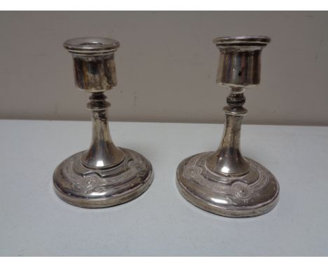 A pair of silver squat candlesticks in celtic design CONDITION REPORT: Small knock to one sconce