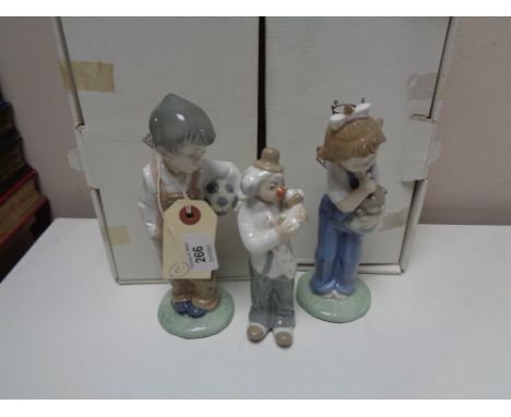 Two Nao figures of children together with a further Cascades figure, all parts boxed. (3)