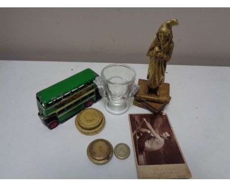 A box of antique brass figure - Scrooge, scale weights, Dinky toys bus, glass egg cup, monochrome photograph 