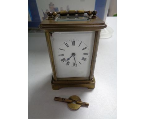 A twentieth century brass carriage clock with key CONDITION REPORT: Loss to enamel dial in upper corner. Winds and runs. 