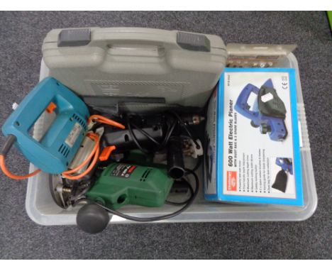 A crate of tools, electric drill, jigsaw, router, electric planer, etc