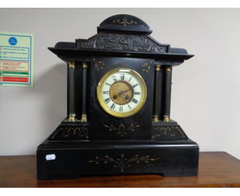 A nineteenth century black slate and gilt highlighted mantel clock 