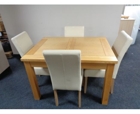 A contemporary light oak extending dining table with four cream leather chairs  CONDITION REPORT: Table photographed 90 cm x 