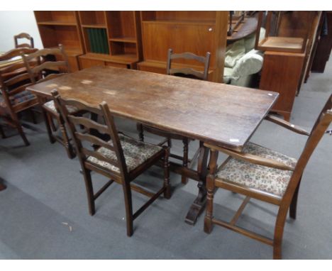 An oak refectory dining table together with six ladder backed chairs 