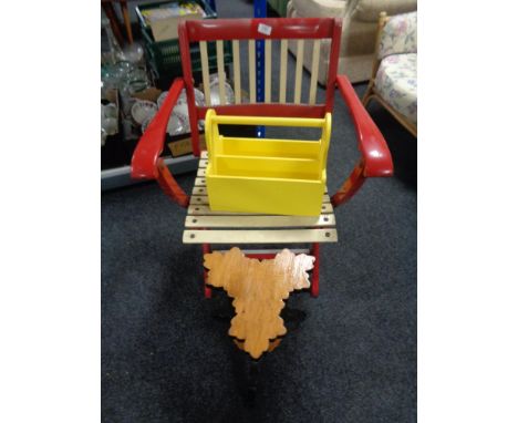 A vintage folding chair together with a wooden plant stand 