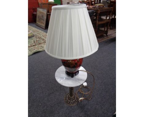 A marble topped metal stand together with a ceramic table lamp with shade 