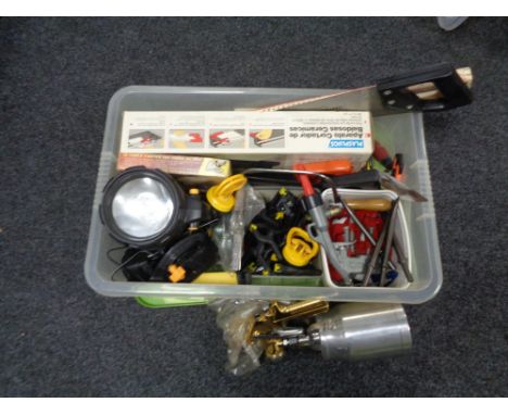 A crate containing tools, saw, clamps, paint spraying pod, torch