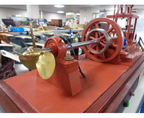 A large model Walking Beam Marine Engine 1904, on plinth under glass cover, 87cm by 42cm by 31cm overall.