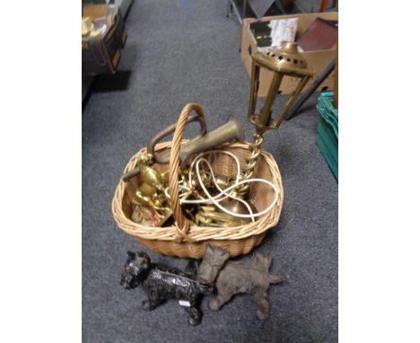 A wicker crate of brass, cast Scotty dog figures, brass bugle etc 