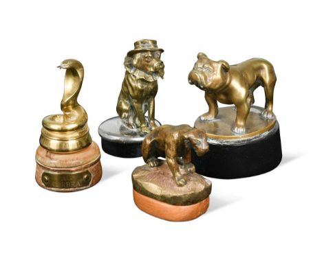 A group of four brass car mascots, to include a 1950s Desmo Bulldog, raised on an ebonised wooden plinth 7 x 12cm a converted