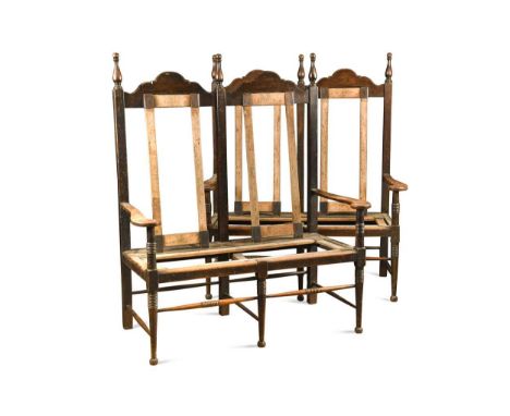 William Birch (1840-1954), probably for Liberty, a rare pair of oak settles, each with turned finials and arched backs over o