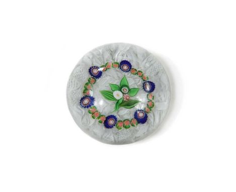 A Clichy glass garlanded paperweight, with central posy within a garland of Clichy roses interrupted by large red, white and 