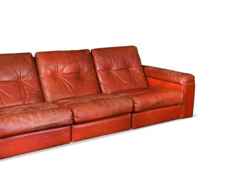 A Tetrad modular four-seat sofa, upholstered in red leather75 x 302 x 101cmWear,&nbsp;paricularly to the corners and extremit