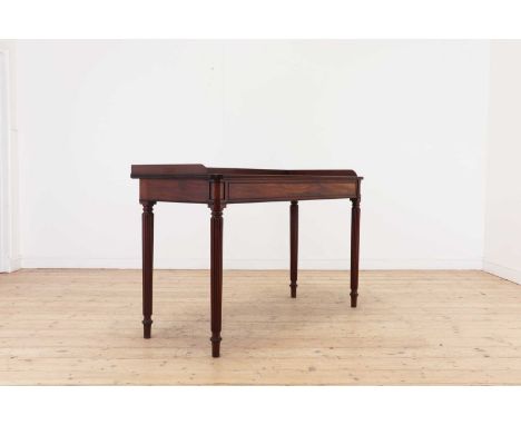 A George IV mahogany serving table,c.1825, the galleried, rounded rectangular top, above a moulded frieze, raised on tapering