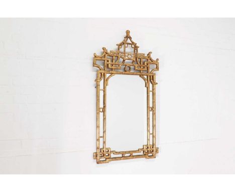 A chinoiserie giltwood mirror, of recent manufacture, Italian, the faux bamboo frame surmounted with a pagoda and scrolls, su