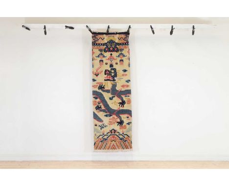 A wool runner, 20th century, Chinese, decorated in polychrome with dragons, 218 x 73cmProvenance: The Late Sir John Craven, T